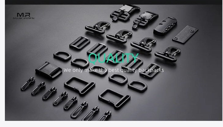 Black metal backpack hardware including YKK zippers, buckles, and D-rings arranged on a dark surface, emphasizing quality craftsmanship for Mark Ryden backpacks.