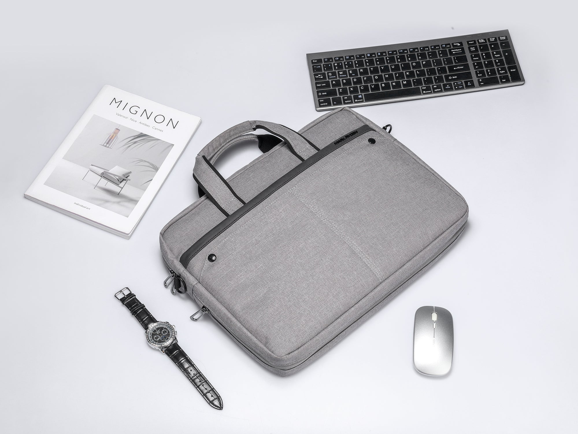 Gray Mark Ryden anti-theft laptop bag with black accents, handles, and office accessories