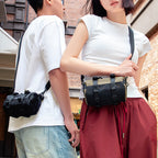 MarkRyden Global's MotoBarrel cylinder crossbody bag with strap, fashion-forward style on couple in city