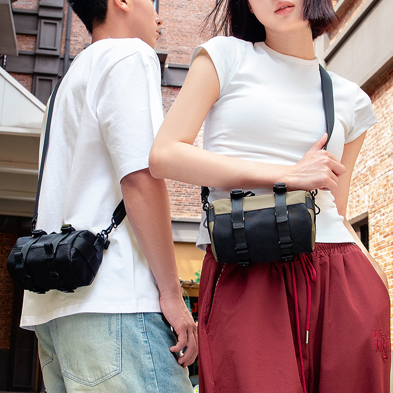 MarkRyden Global's MotoBarrel cylinder crossbody bag with strap, fashion-forward style on couple in city