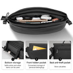 Black TravelProPack travel backpack with open main compartment holding notebook, earbuds, and other items; features bottom storage for selfie sticks, front hidden pocket, and back anti-theft pocket.