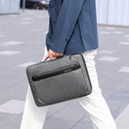 Gray anti-theft business laptop case carried by modern traveler in urban setting - MarkRyden Global