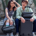 Casual II black leather waterproof scratch-resistant stylish messenger bag carried by a woman outdoors with a suitcase, perfect for modern travelers.