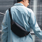 Mark Ryden Global: Sleek black daily crossbody bag with orange accent, modern style