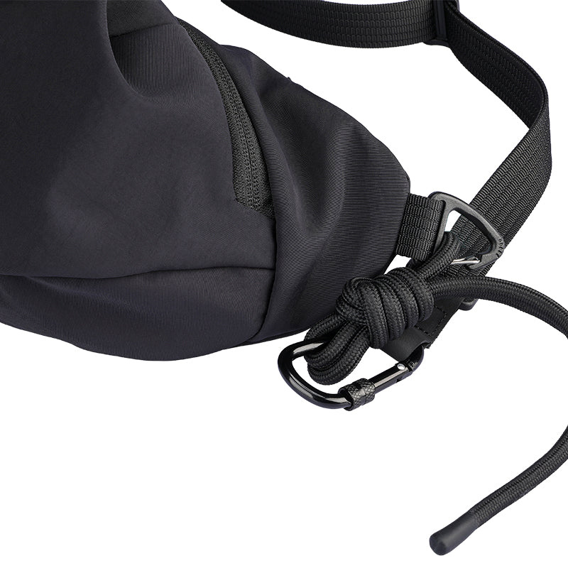 Black ChillFlex sling bag with adjustable strap, carabiner & paracord detail - modern anti-theft travel accessory