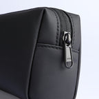 Black portable large capacity traveling toiletries bag with textured exterior, front pocket, and metal zipper pull.
