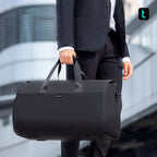 Mark Ryden Global black water-resistant business travel bag held by businessman in formal suit
