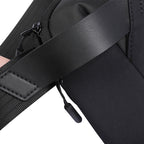 Close-up of Vivi travel bag by MarkRyden, highlighting black leather strap with stitching, durable fabric, and zipper pull.