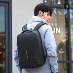 Man wearing black Mark Ryden Slim II upgraded high-capacity backpack, ideal for traveling and commuting.