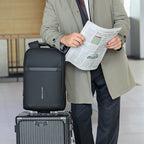 Mark Ryden Voyager Pro lightweight black commuter backpack on suitcase