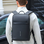 Black Mark Ryden Voyager Pro lightweight backpack with sleek design and front pocket, worn by a commuter in an urban setting.