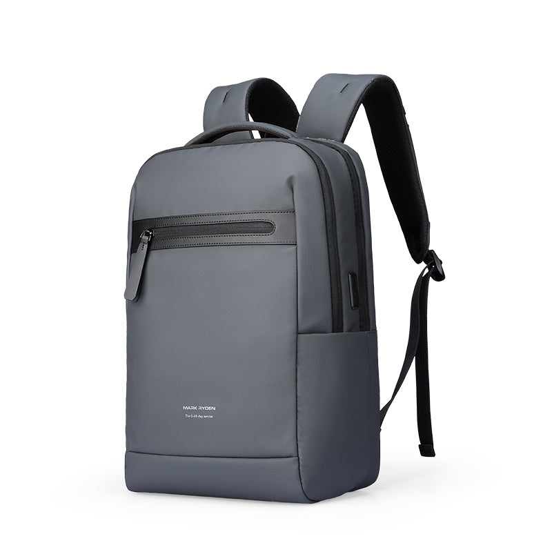 Gray UrbanFlex Lite lightweight backpack with separate computer compartment, sleek design, black padded straps, front zip pocket, designed for business use by Mark Ryden.