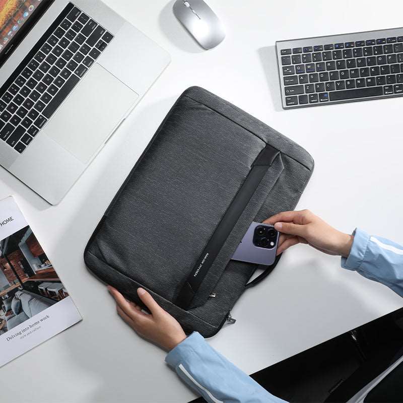 Dark gray anti-theft business laptop case with phone pocket on office desk