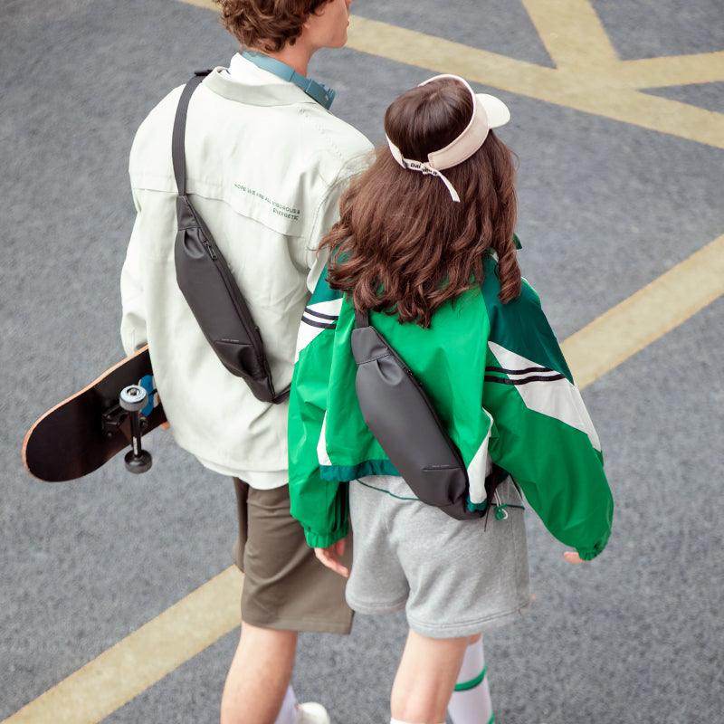 Two people walking outdoors with MarkRyden super lightweight daily crossbody bags