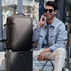 Mark Ryden Global explorer anti-theft backpack on luggage, man talking on phone