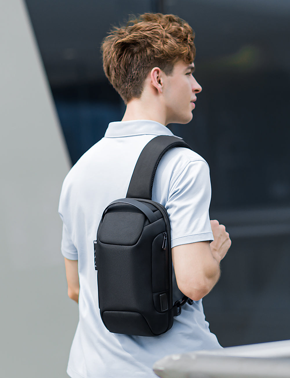 Mark Ryden Global's Odyssey Mini black anti-theft waterproof crossbody bag worn by man