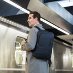 Mark Ryden UrbanLite Pro sleek water-resistant business travel backpack at subway station