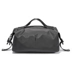 Mark Ryden AquaCube 3D waterproof organizer cube in charcoal gray with top handle and adjustable side straps for packing.