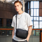 Model wearing black waterproof PU leather sling bag in modern setting | MarkRyden Global
