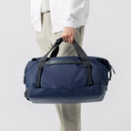 MarkRydenGlobal NomadFlex waterproof navy gym bag being carried