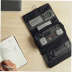 Mark Ryden MagiClip black toiletry bag with mesh pockets on wooden desk