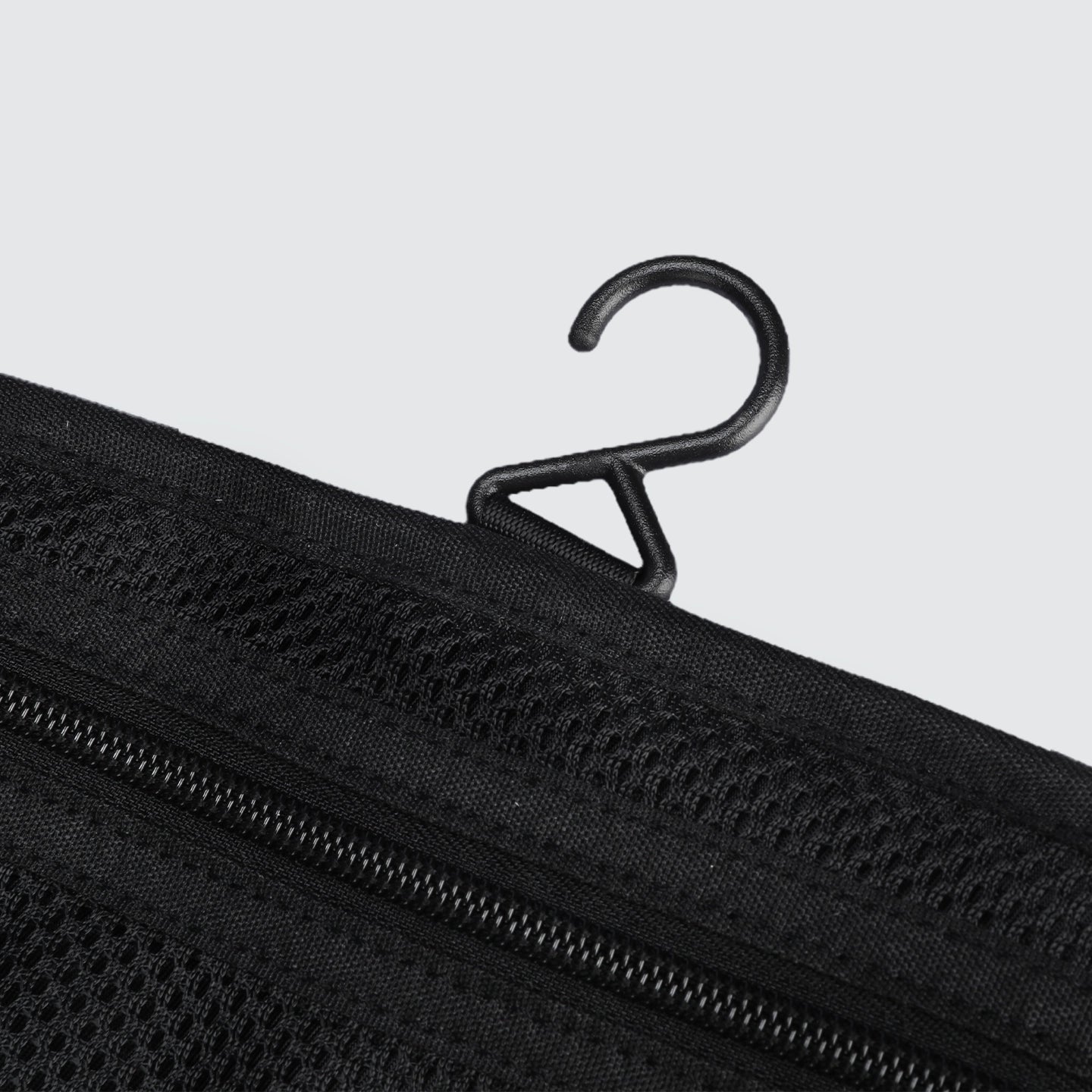 Black mesh wet-dry separate toiletry bag featuring MagiClip hook and zippers, designed for daily use.