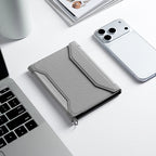 MarkRyden Global's gray instant-access crossbody travel card wallet, modern design, near phone & laptop