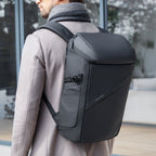Black AeroShield 2025 durable waterproof backpack with smooth material, sleek modern design, and front pocket, worn by a person in a light coat