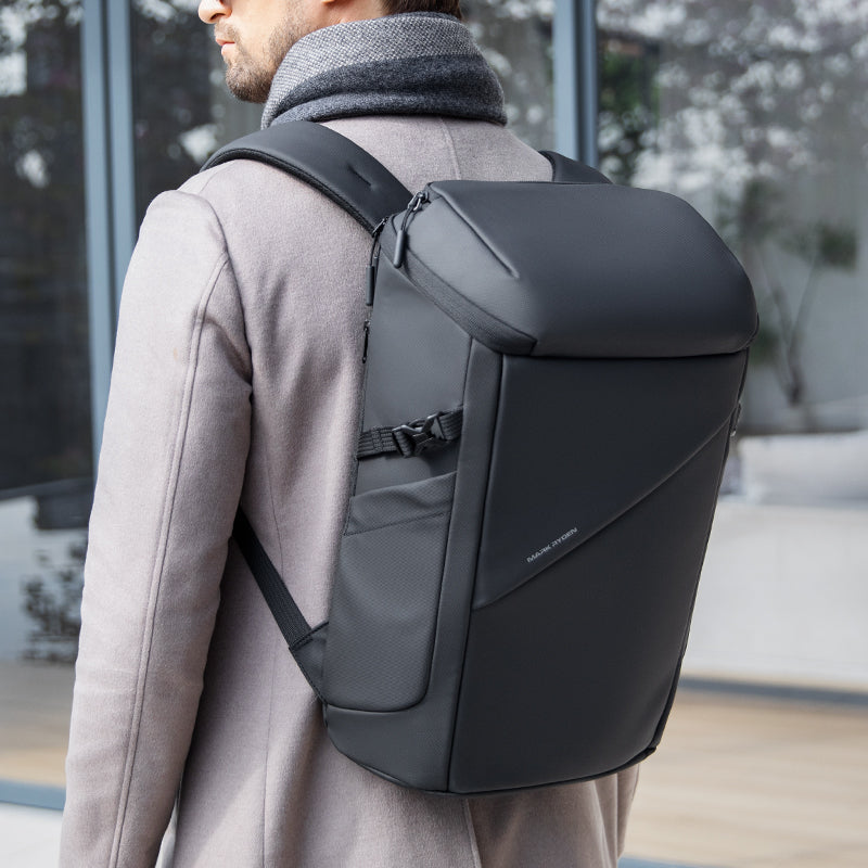 Black AeroShield 2025 durable waterproof backpack with smooth material, sleek modern design, and front pocket, worn by a person in a light coat