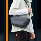 Mark Ryden Global: Gray large capacity city commuter messenger bag on person in light jacket