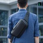 Mark Ryden Global: Man in blue shirt wears sleek black compact cross-body sling bag