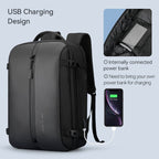 Black Mark Ryden Compact High-Capacity Smart USB Laptop Backpack with external USB charging port, shown charging a smartphone, featuring internal power bank connection (requires own power bank)